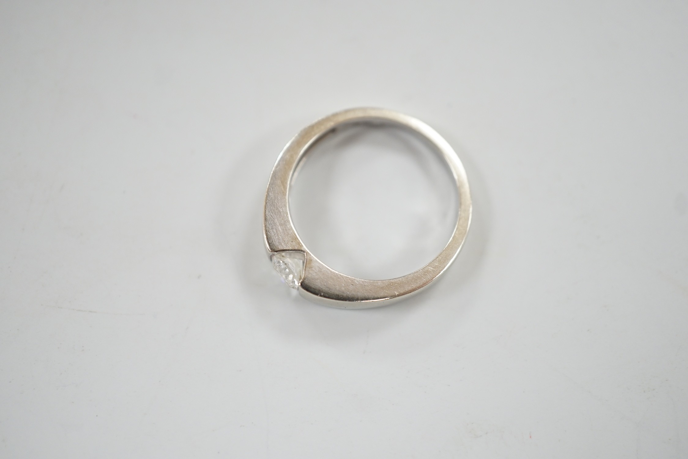 A modern 9ct white gold and solitaire diamond set ring, the stone weighing 0.34ct, size M/N, gross weight 3.2 grams.